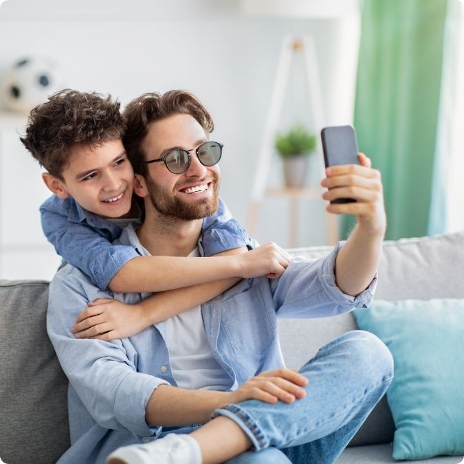 Father and son taking a selfie wearing Avulux lenses