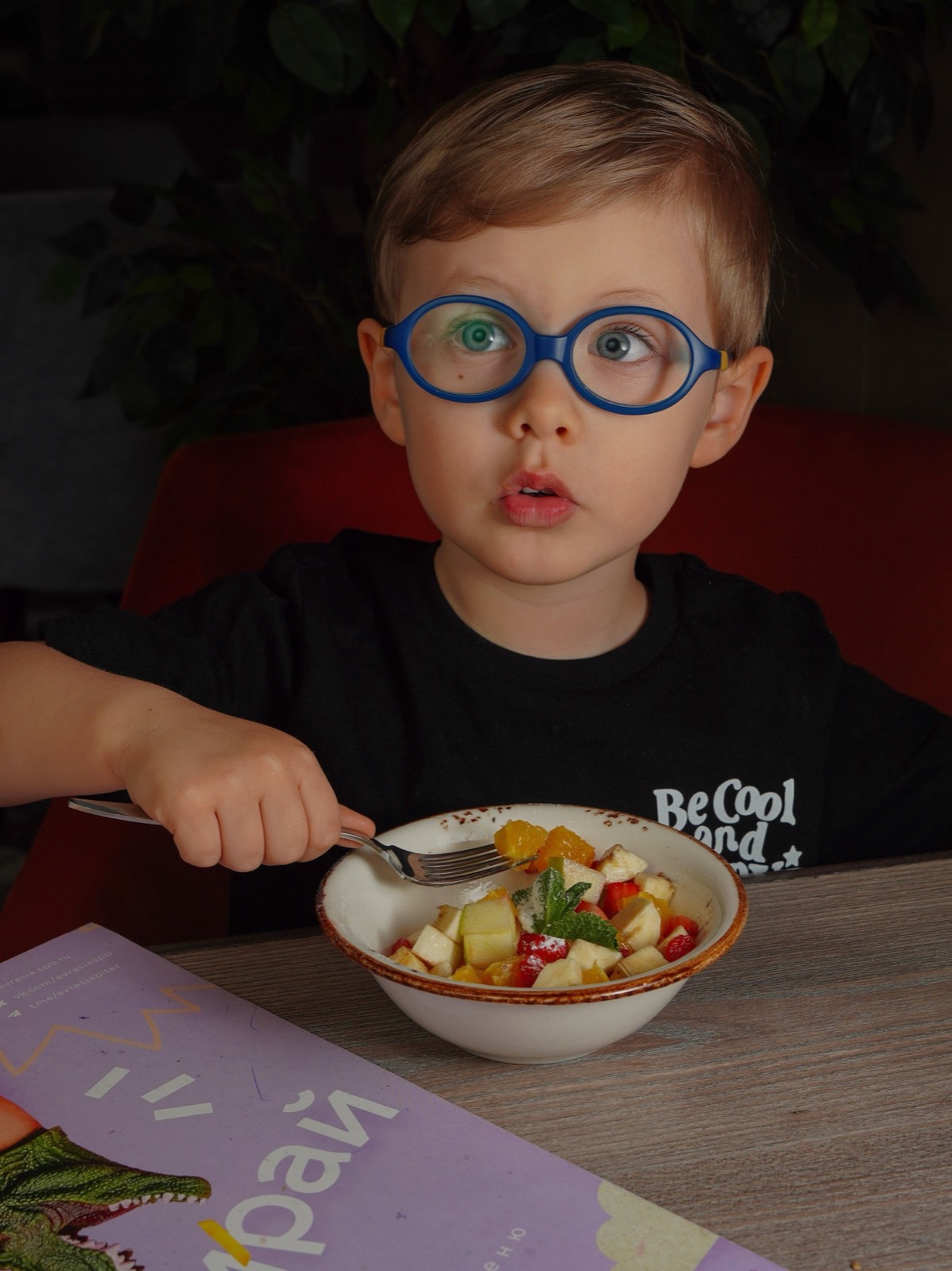 Young child wearing blue glasses, ready for a clear school year