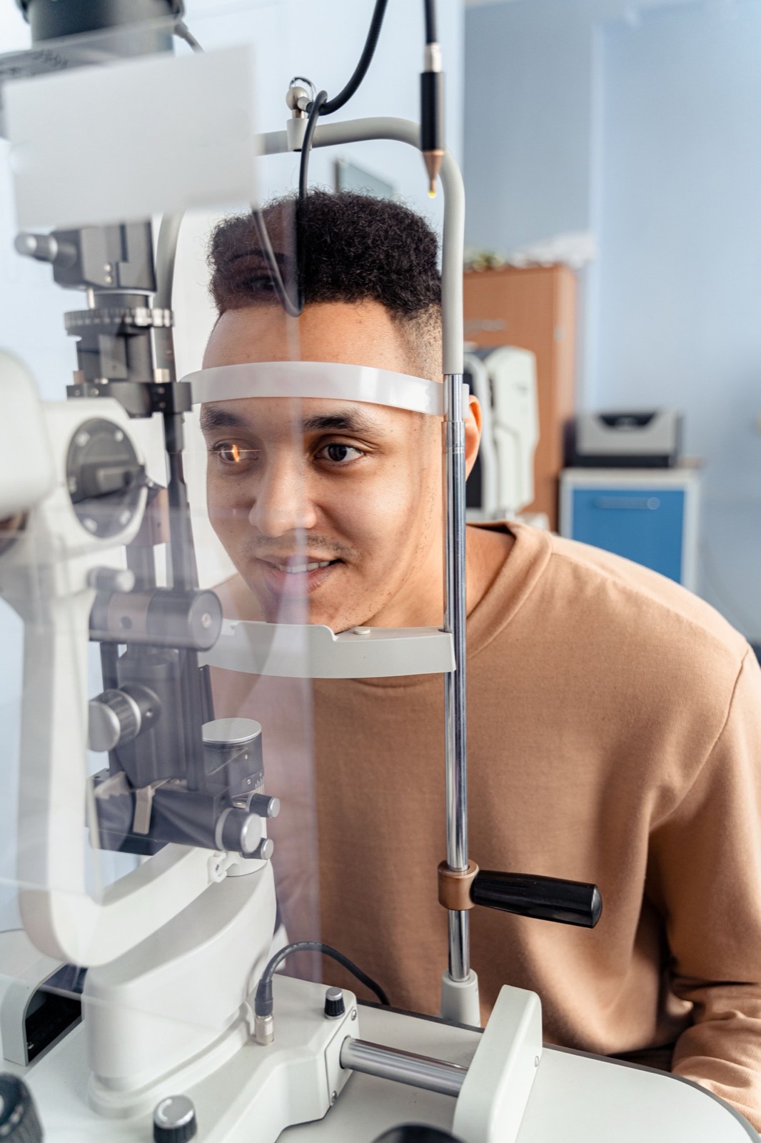 Patient receiving a comprehensive eye examination at a slit lamp