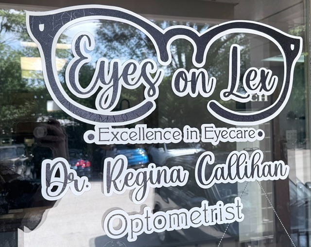 Glass door sign showing doctor name