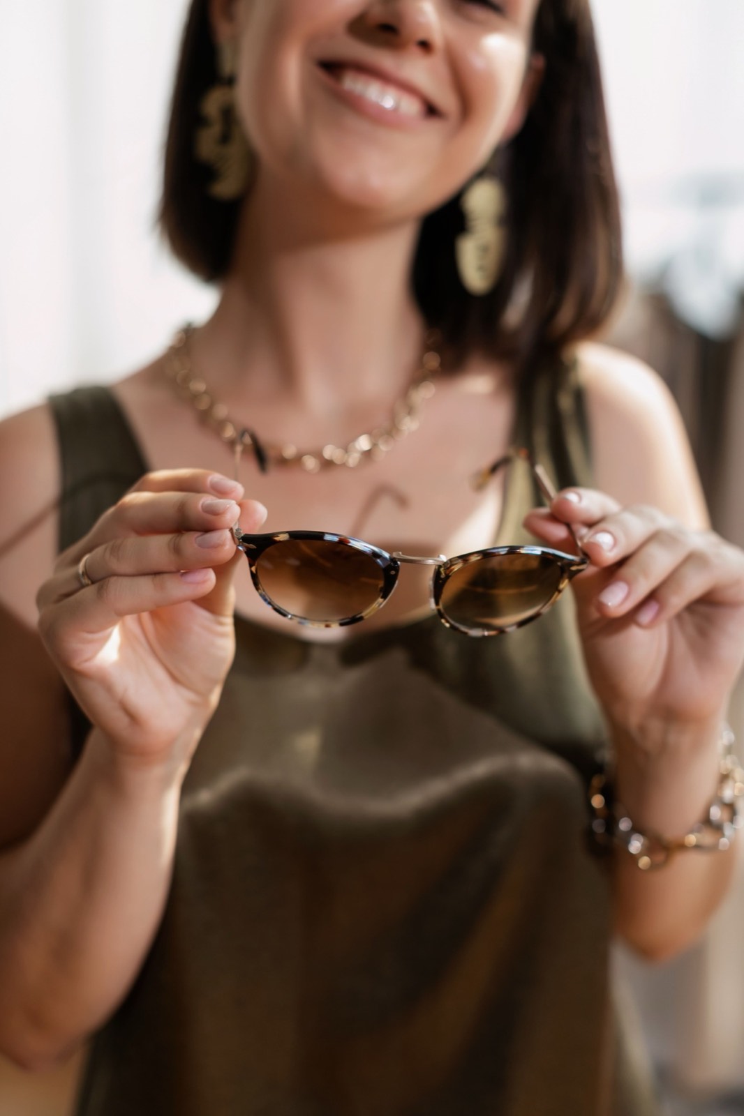 Woman selecting a pair of tortoiseshell sunglasses